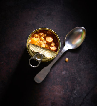 Spoon and opened can with lentil soup