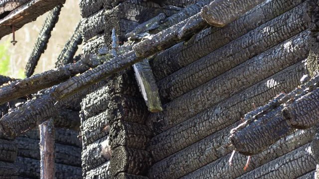 burnt wooden log house, charred wood