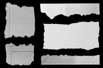 Torn papers on black