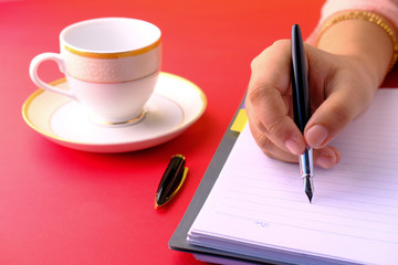 women hand writing on notepad, copy space.