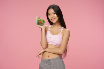 Cheerful woman slim figure salad meal