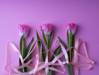 beautiful pink gift tulips with notepad and pen for woman