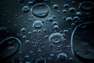 Macro shots cooking oil mixed with water on the glass surface 