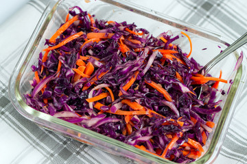 Vegetarian salad with shredded red cabbage and carrot.