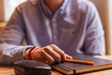 stylish man working at home. home office essentials. pen in hand closeup. boy studying. successful man at work 