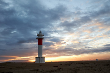 Lighthouse Fangar, in Tarragona, Spain, at sunset