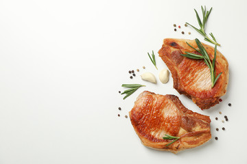 Fried steaks with spices on white background, top view