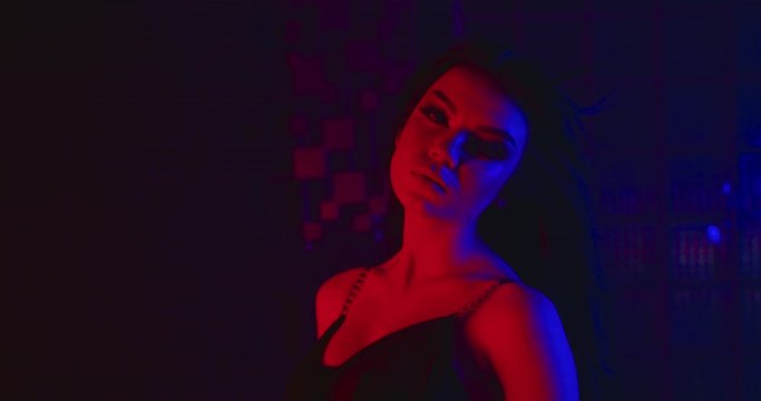 The girl is posing sexually and playing with her hair and looking at the camera. Fashion looks. Blue-red neon. 4k