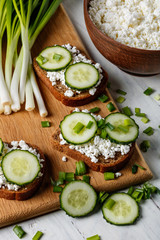 sandwiches with cottage cheese and slices of cucumber on the table