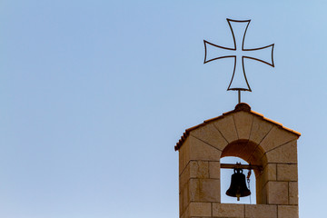Cross and bell on top of the church at Tabgha, Israel, where Jesus is supposed to have multiplied bread anf fishes