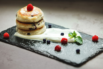 A Syrniki cake sitting on top of a table