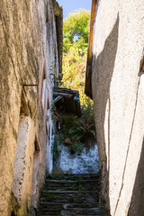 old alpine village built on top of a mountain. Bell towers,Houses and stone roofs