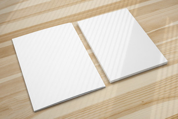 Blank folder and letterheads stack on wooden desk with shadow overlay as template for design, logo presentation, branding mock-up etc.