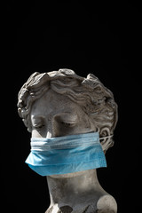antique statue head in a protective mask