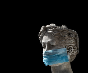 head of a female Italian statue in a protective mask with a sad look