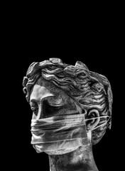 Italian statue in a protective mask with a sad look