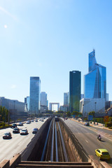 Obraz premium Paris, France - August 26, 2019: Day multi-lane road with skyscrapers of the La Defense