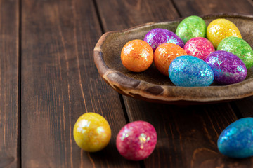 colored easter eggs on a clay plate. holiday concept with copy space