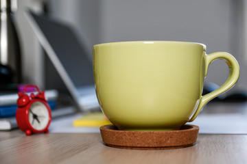 Office table desk. Workspace with clock, cup of coffee, computer and notebooks. Break in the office work