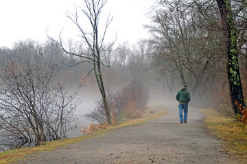 Fototapeta premium Aging Man Walking a Hazy Path Into the Unknown