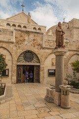 Fototapeta na wymiar City of Bethlehem. The church Catherine next to the Basilica of the Nativity of Jesus Christ. Column with the figure of Saint Jerome