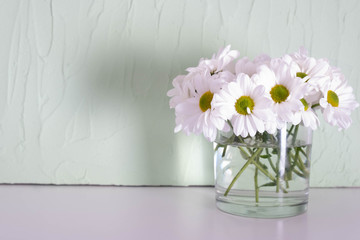 chrysanthemums in a transparent vase on a table