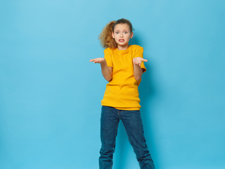 Cheerful beautiful girl yellow t-shirt lifestyle blue background charm Studio
