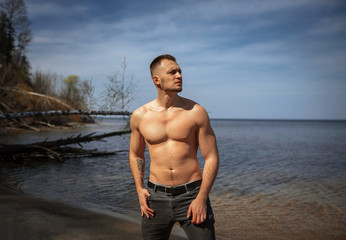 Young guy on a sandy wild beach