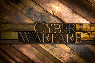 Photo of real authentic typeset letters forming Cyber Warfare text on vintage textured grunge...