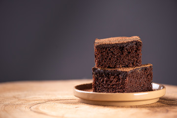 Two pieces of chocolate cake on a table 