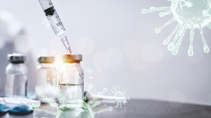 Vaccines and Syringes Used for prevention, immunity and treatment from covid-19 infection or coronavirus. Concepts of disease prevention. Focus on syringes and vials, blurred background.