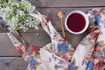 Fototapeta premium on the table is a cup of coffee, next to a women's dress