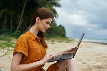 Cheerful beautiful woman laptop travel beach tropics island
