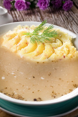 Pure white borscht served with mashed potatoes.