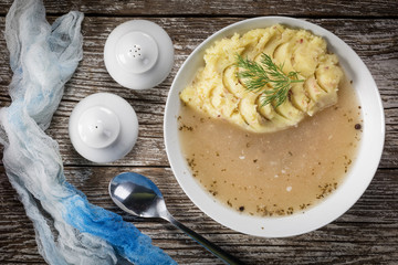 Pure white borscht served with mashed potatoes.