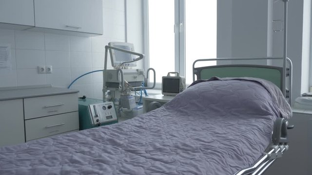 camera approaches an empty medical bed, empty medical ward, intensive care unit