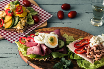 Variety of danish open sandwiches on wooden boards