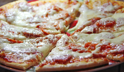 Slices of fresh appetizing pizza with delicious ingredients close up
