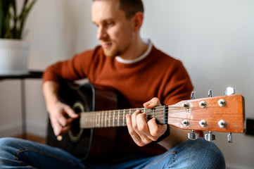 Young attractive guy with an acoustic guitar