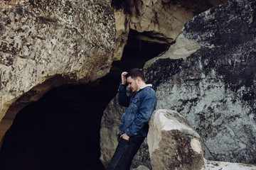 Fototapeta premium Sad young man alone in the mountains
