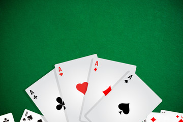 Chips and cards for poker in hand on green table
