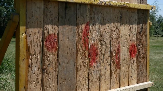 ax throwing to wooden fence