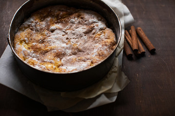 Homemade apple pie on a wooden table in the kitchen