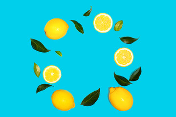 Creative layout made of flying yellow lemon with leaves on green mint color background.