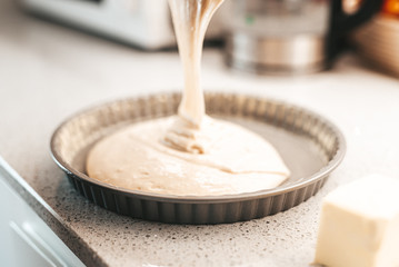 Pouring dough into a 
baking pan
