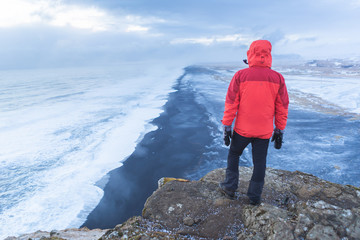 Fototapeta premium Man looking at the view from Dyrholaey Peninsula, near Vik, South Iceland