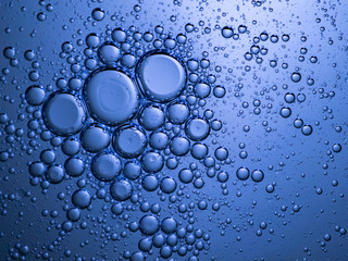 Abstract bubble background in blue. Slightly blurred and selective focus.