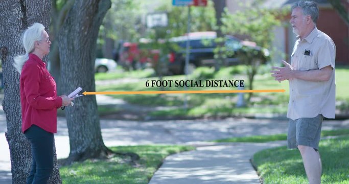 A woman out to collect her mail crosses paths with a neighbor but maintains the six feet social distancing rule as they chat. Graphic added for emphasis.