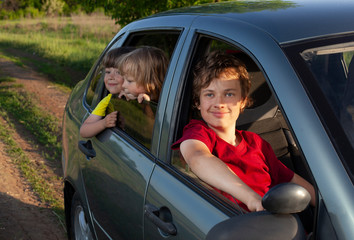 Smiling family with children in the car. Holiday and travel concept