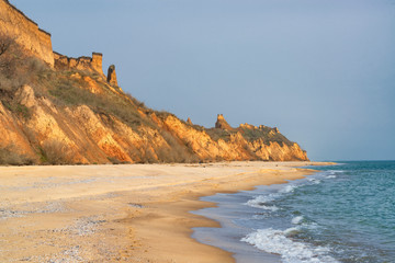Fototapeta na wymiar Sand castles on the empty sea coast